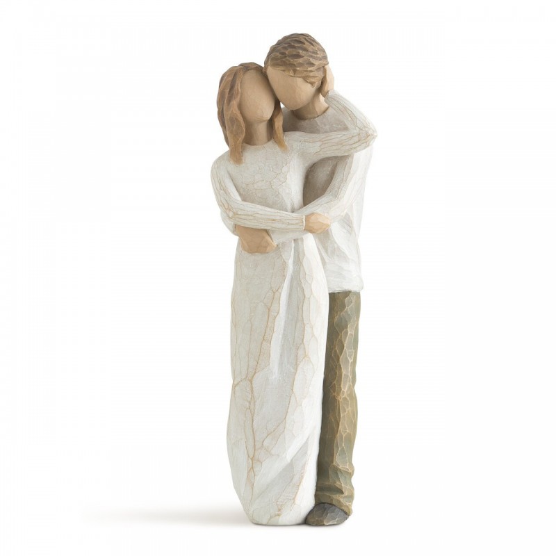 Man hugging woman figurine