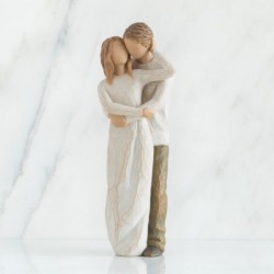 Man hugging woman figurine