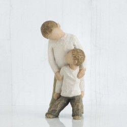 Young boy holding smaller boy figurines