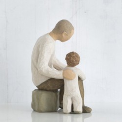 Father and little boy figurine sitting holding hands