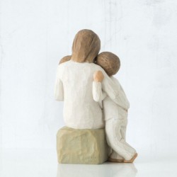 Mother figurine with arms wrapped around two children