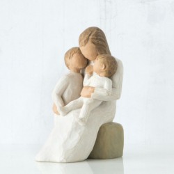 Mother figurine with arms wrapped around two children