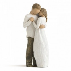 Man and woman figurines holding one another