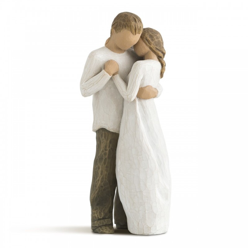 Man and woman figurines holding one another