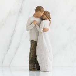 Man and woman figurines holding one another