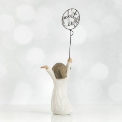 Front view of little girl with brown hair and both arms in the air as she holds a wire balloon. Text on balloon is wire