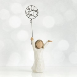 Front view of little girl with brown hair and both arms in the air as she holds a wire balloon. Text on balloon is wire