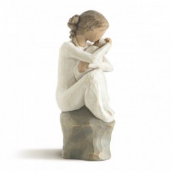 Faceless girl sitting on grey rock with arms holding baby