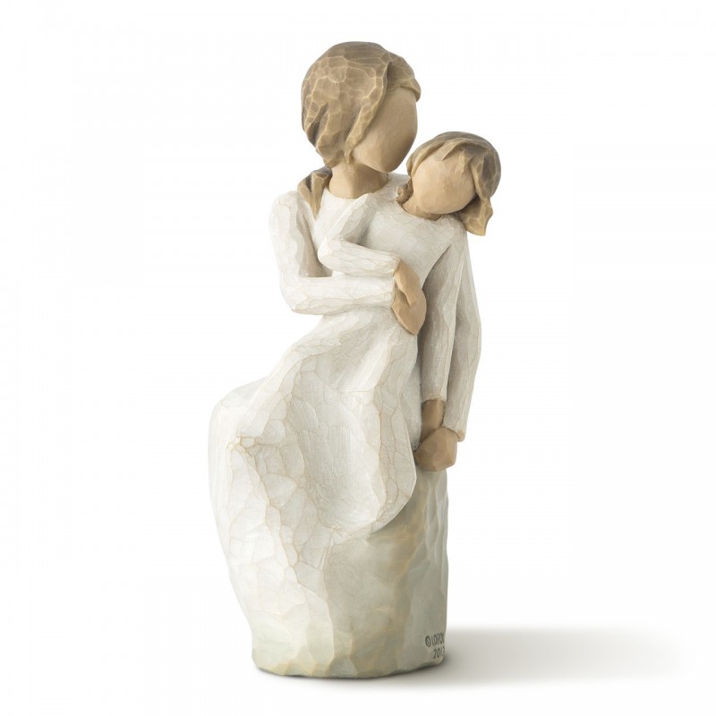 Woman figurine in white dress holding younger girl in her arms