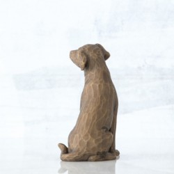 Brown dog figurine sitting turning to the side