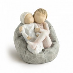 Young girl figurine sitting in light pink dress holding tiny baby in her arms - sitting on grey plush bean bag