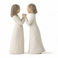 Two little girl figurines facing one another holding hands