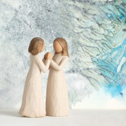 Two little girl figurines facing one another holding hands