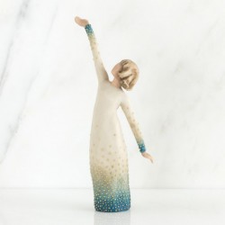 Woman figurine holding both her hands in different directions in white dress with blue on it embellished with crystals