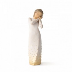 Front view of brunette girl figurine in white dress with gold dots holding her hands to her face