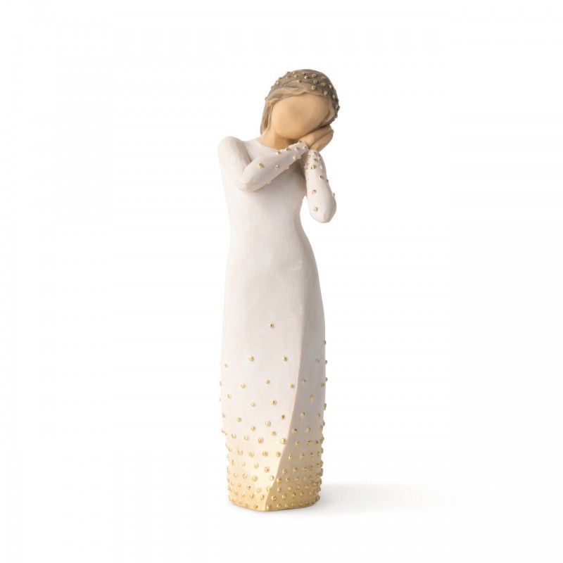 Front view of brunette girl figurine in white dress with gold dots holding her hands to her face