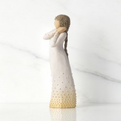 Front view of brunette girl figurine in white dress with gold dots holding her hands to her face