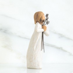 Woman figurine holding black flowers to her face