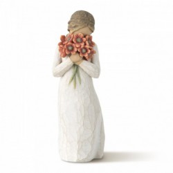 Little girl figurine holding red flowers