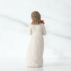 Little girl figurine holding red flowers