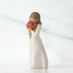Little girl figurine holding red flowers