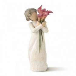 Front view of little girl with short brown hair holding a cluster of red calla lilies