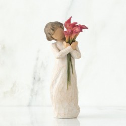 Front view of little girl with short brown hair holding a cluster of red calla lilies