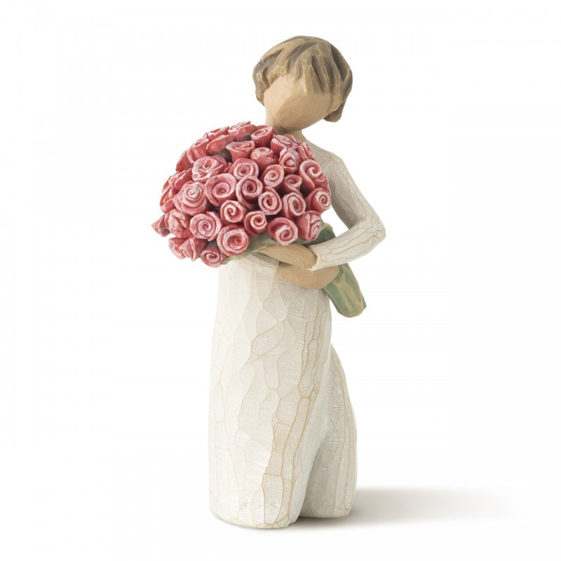 Small girl figurine in white dress holding pink flower bouqet