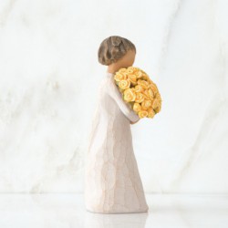 Front view of little girl with short brown hair holding a large bouquet of yellow roses