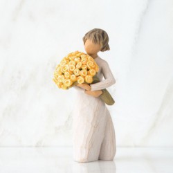 Front view of little girl with short brown hair holding a large bouquet of yellow roses