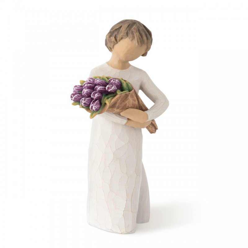 Girl figurine in white dress carrying purple flowers in arms