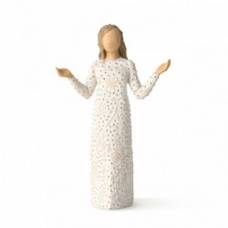 Front view of brunette girl figurine in white dress with gold dots holding her hands out