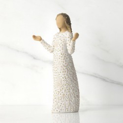 Front view of brunette girl figurine in white dress with gold dots holding her hands out