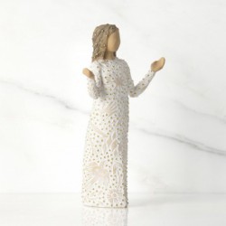 Front view of brunette girl figurine in white dress with gold dots holding her hands out