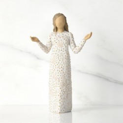 Front view of brunette girl figurine in white dress with gold dots holding her hands out