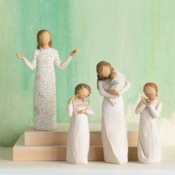 Front view of brunette girl figurine in white dress with gold dots holding her hands out