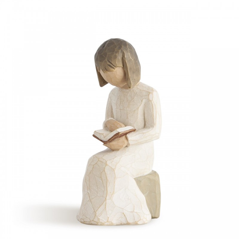 Little girl figurine sitting down reading a book