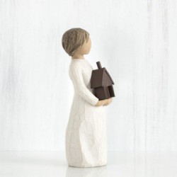 Little girl figurine holding brown bird house