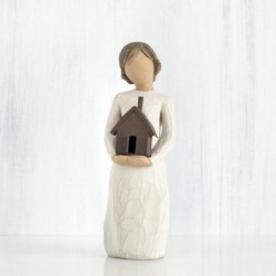 Little girl figurine holding brown bird house