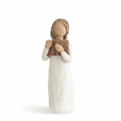 Faceless girl figurine wearing white dress holding brown book