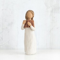 Faceless girl figurine wearing white dress holding brown book