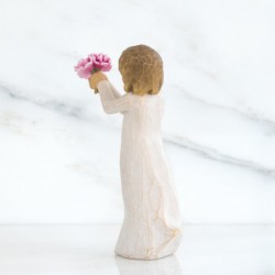 Front side view of girl with light brown hair holding out pink flowers with both hands