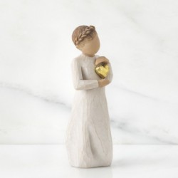 Young girl figurine holding gold heart