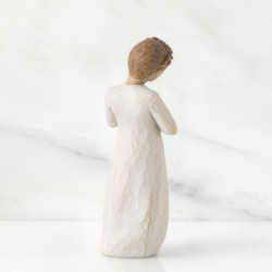 Young girl figurine holding gold heart