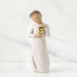 Young girl figurine holding gold heart