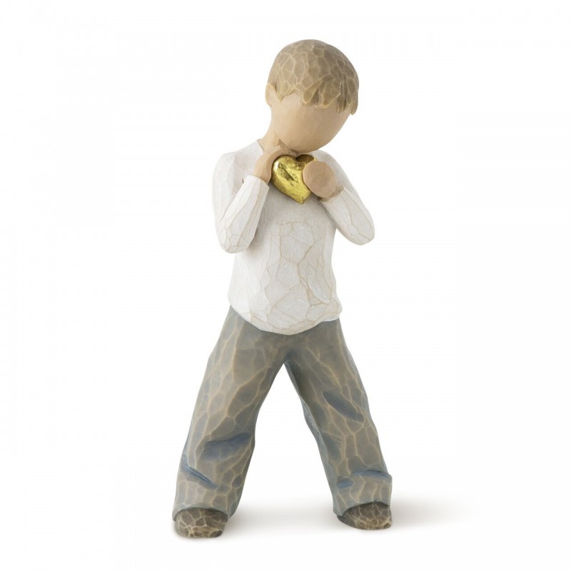 Little boy figurine standing holding gold heart