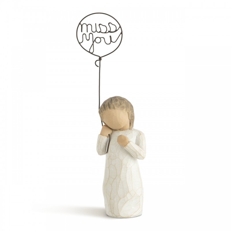 Small girl figurine holding 'miss you' balloon