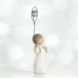 Small girl figurine holding 'miss you' balloon