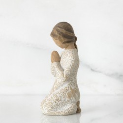 Young child figurine praying