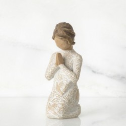 Young child figurine praying